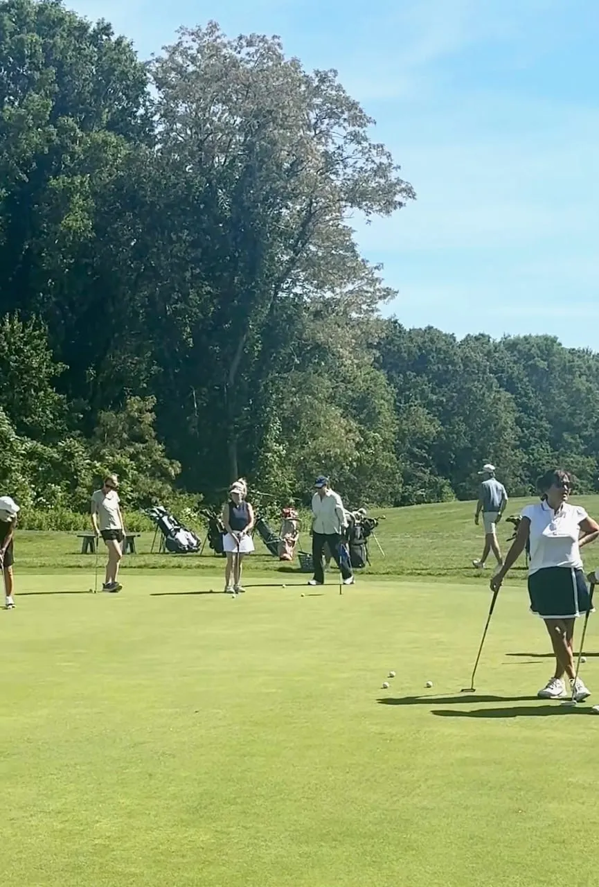 Women practicing on the putting green